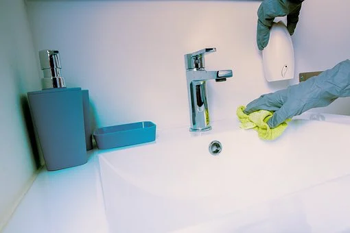 Keep your bathroom clean and fresh with ECG services. Bathroom being cleaned.