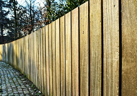 Fencing installation and repairs understaken. Long wooden fence.